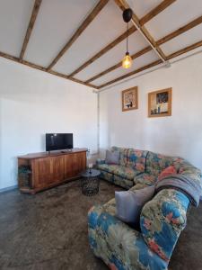 a living room with a couch and a flat screen tv at Casa Rocio in Güimar