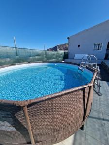 a large swimming pool with a wicker basket around it at Casa Rocio in Güimar