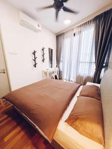 a bedroom with a large bed with a ceiling fan at PROMO Connected train 4 Bedroom ABOVE MALL 20 in Kuala Lumpur