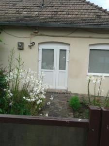a house with a white door and a fence at CASA DIDINA fosta Pensiune Casa Didina in Bacău +8 photos