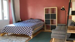 a bedroom with a bed and a chair at Les bords de Seine in Vernon