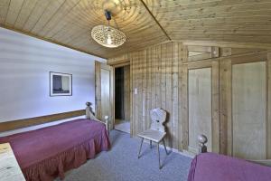una camera con un letto e una sedia di Chesa Raetia - Pontresina a Pontresina