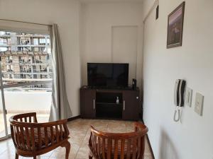 a living room with two chairs and a television at Departamento Augusta II in Posadas