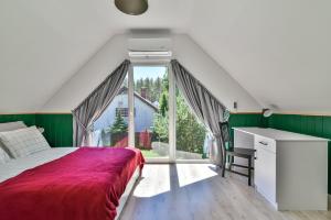 - une chambre avec un lit, un bureau et une fenêtre dans l'établissement Domki z Pasją, à Kopalino