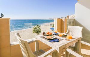 a dining table with a view of the beach at 1 Bedroom Stunning Apartment In Fuengirola in Fuengirola
