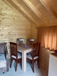 a dining room with a wooden table and chairs at Wooden Corner in Kolašin +49 photos