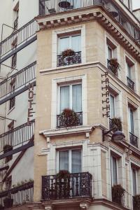 a tall building with balconies and plants on it at Hotel Panache in Paris