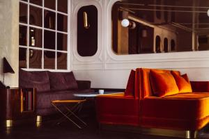 a living room with a couch and a table at Hotel Panache in Paris