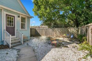 a yard with a fence and a house at FRIENDS AIRBNB Themed 2bed 2bath walkable to all of Ybor in Tampa