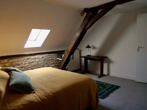 a bedroom with a bed and a skylight at Grande maison - village de Noyers - 5 chambres in Noyers-sur-Serein