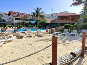 a beach with lounge chairs and a swimming pool at Albis Harena - Porto Antigo 2 in Santa Maria