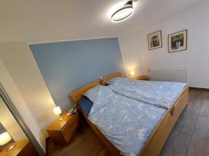 a small bedroom with a bed and two night stands at a Bäckesch 15 in Nettersheim