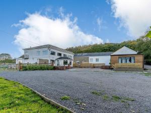 a house with a driveway in front of a house at The Cottage-uk32854 in Alltwen