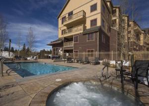 a house with a swimming pool in front of a building at Red Hawk Lodge by Summit County Mountain Retreats in Keystone