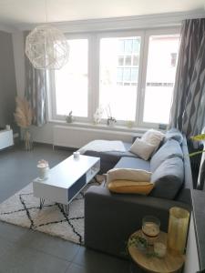 a living room with a couch and a table at La casa di Deborah in Namur