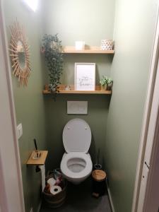 a small bathroom with a toilet with shelves at La casa di Deborah in Namur