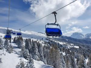 a ski lift going up a snow covered mountain at Weinberg Apartments & Acquarenacard in Naz-Sciaves