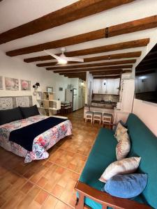 a bedroom with a bed and a living room at Marine Studio on the Beach in Icod de los Vinos