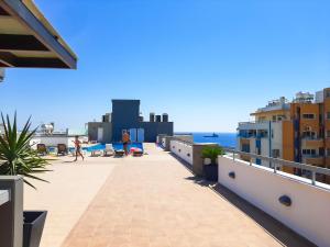 a balcony with a view of the ocean and buildings at Eden Sea Breeze, 1 bed, Rooftop Pool, Gym in Limassol