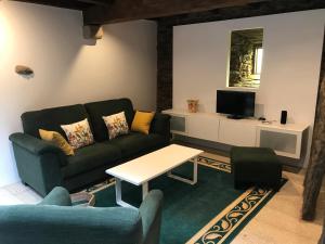 a living room with a couch and a table at A Casacuberta in Marquiño