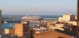 a cruise ship is docked in a harbor at B&B Di Mare in Porto Empedocle