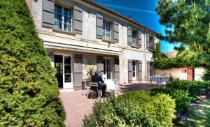 two people sitting in front of a building at Ferme du Roy in Anserville