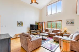 a living room with couches and a flat screen tv at Mountain Vistas in Silverthorne