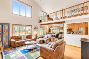 a living room with couches and a staircase at Mountain Vistas in Silverthorne