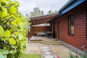 a patio of a house with a table at Remigija Studio Home in Jonava