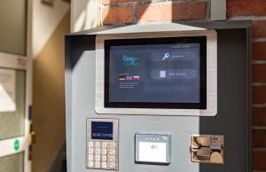 an atm machine with a pay box on it at Stadt-gut-Hotel Großer Kurfürst in Emden