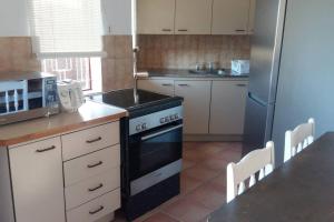 a kitchen with a black stove and a refrigerator at 2Bed 2Bath Vacation home with pool close to beach in Margate