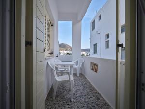 a corridor with a table and chairs in a room at Pension Paros Anna Spanou in Parikia