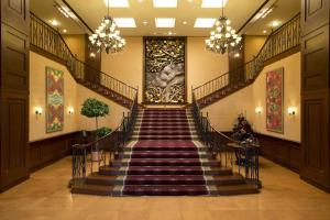a staircase in a building with a painting on the wall at Fruit Park Fujiya Hotel in Yamanashi