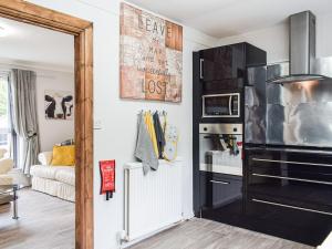 a kitchen with a black refrigerator in a room at Meadow View in Lochgelly