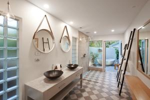 a bathroom with two sinks and a large mirror at Orpheus Island Lodge in Orpheus Island