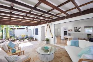 a living room with white furniture and a table at Orpheus Island Lodge in Orpheus Island