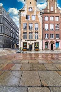 a large building in the middle of a street at Dluga 66 Attic in Gdańsk