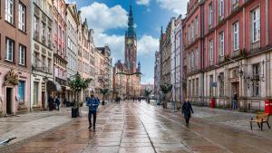 a city street with a clock tower in the distance at Dluga 66 Attic in Gdańsk
