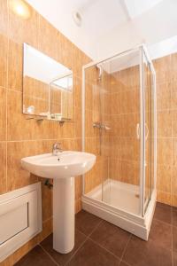 a bathroom with a sink and a shower at West Gate Studios in Bucharest