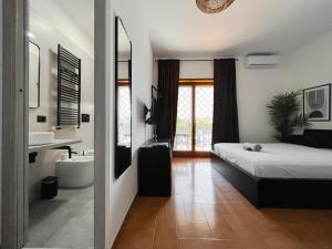 a bedroom with a bed and a bathroom with a sink at Appartamento di design in Rome