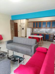 a living room with two couches and a kitchen at GCM 1 ROOMS kentro k parking in Katerini