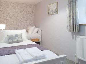 een slaapkamer met een bed met handdoeken erop bij Ty Celyn Farmhouse in Pont Yates