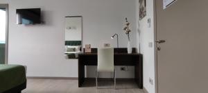 a desk with a white chair in a room at Suites Direzionale Carpi in Carpi +19 photos