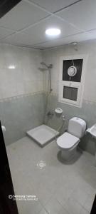 a bathroom with a toilet and a sink at Apartment in Ajman,Studio flat in Ajman 