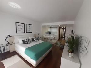a bedroom with a large bed and a living room at Health Village Apartments in Cascais +84 photos