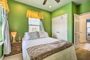 a green bedroom with a bed and a window at 5 Mi to Bourbon St NOLA Home with Fenced Yard! in New Orleans