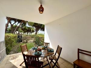 a dining room with a table and four chairs at Albufeira Cosy by Homing in Albufeira