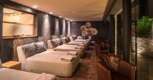 a row of couches and chairs in a room at Hotel Kaprunerhof in Kaprun