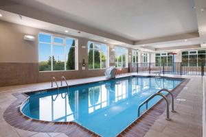 a swimming pool in a hotel with windows at Holiday Inn Jackson NW - Airport Road, an IHG Hotel in Jackson