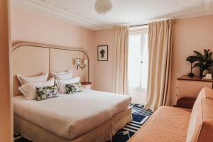 a hotel room with a bed and a window at Hôtel Bienvenue in Paris